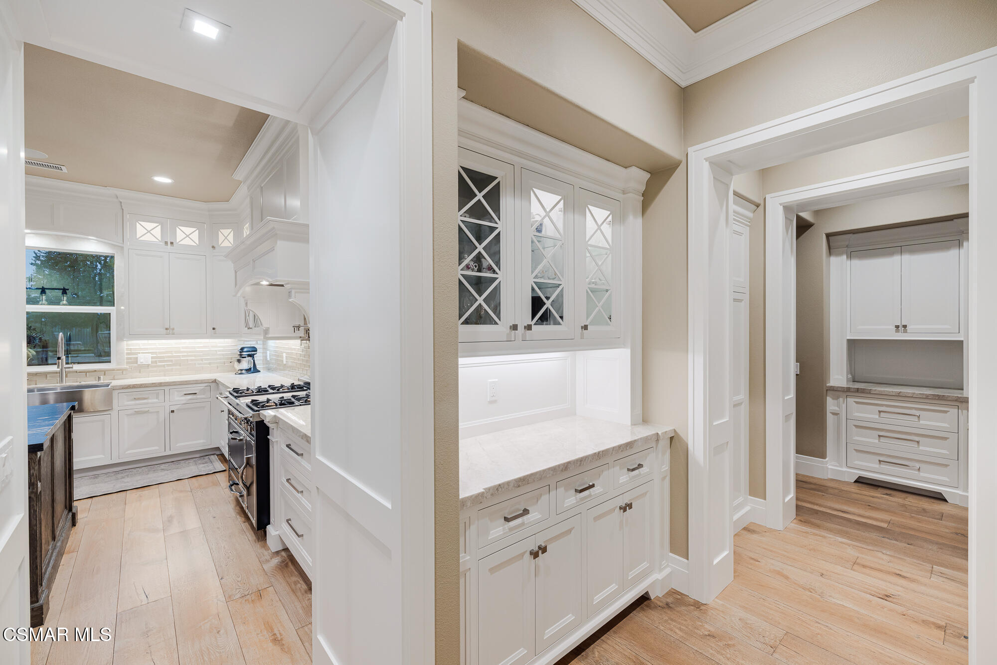 6508 High Country Place Moorpark, CA 93021 - Photo 12 of 95 a kitchen with white cabinets and stainless steel appliances