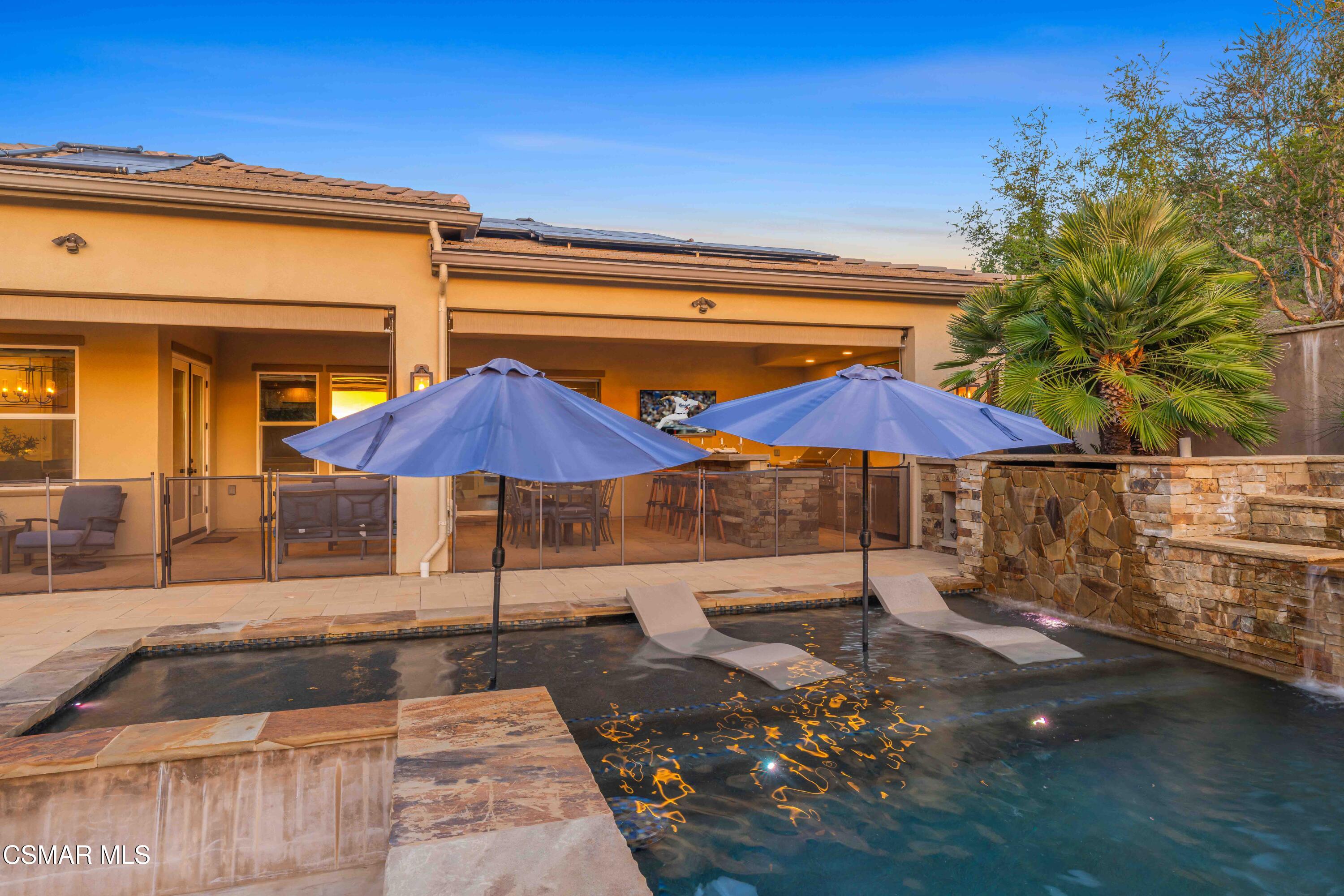 6508 High Country Place Moorpark, CA 93021 - Photo 66 of 95 a patio with a table and chairs under an umbrella