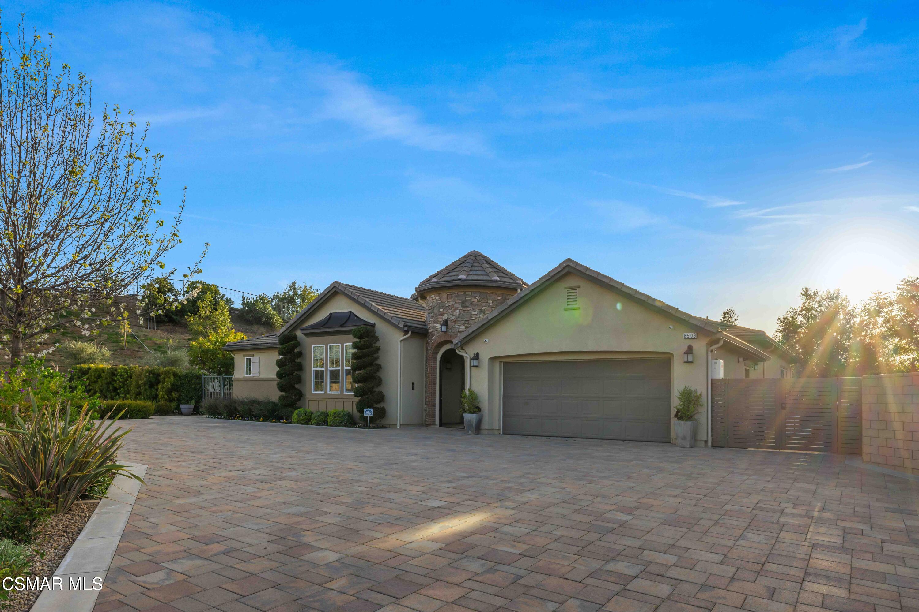 6508 High Country Place Moorpark, CA 93021 - Photo 85 of 95 a front view of a house with a yard and garage