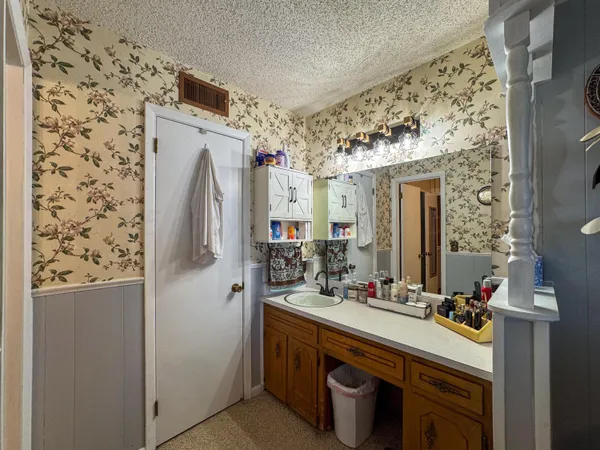a bathroom with a sink mirror and shower