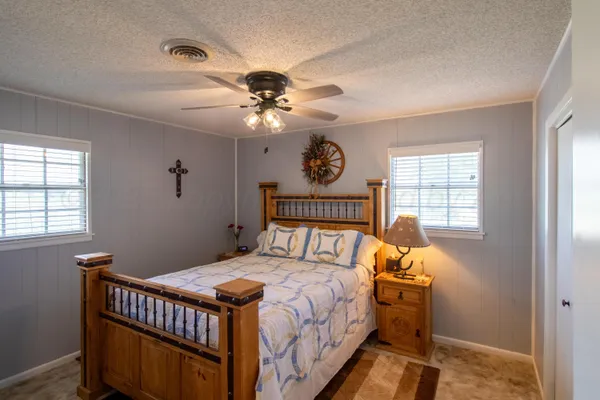 a bed sitting in a bedroom next to a window