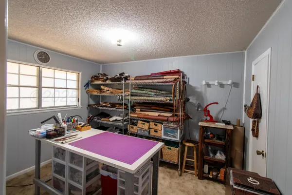 a room with furniture a air conditioner vent and a window