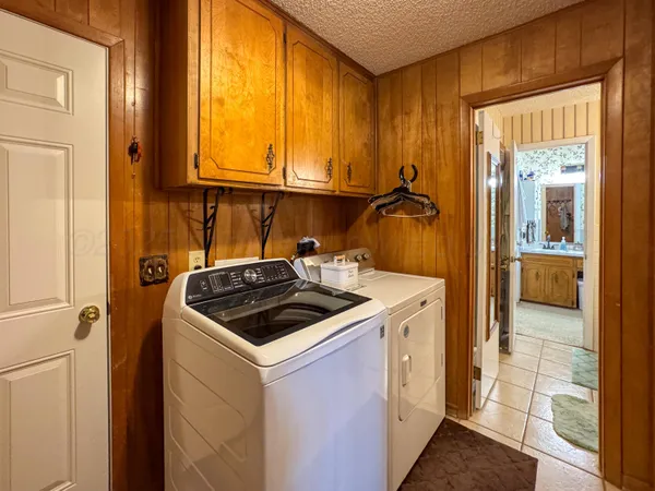 a kitchen that has a sink and a stove next to a window