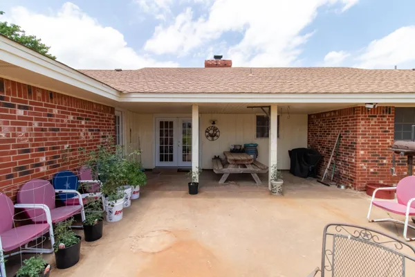 a view of a patio with a table and chairs in patio