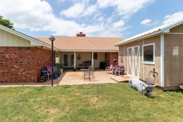 a view of a house with backyard porch and sitting area