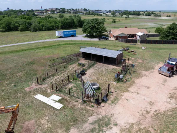 aerial view of a house with a yard lake view and mountain view