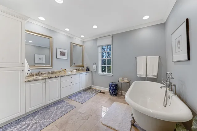 a bathroom with a granite countertop sink mirror and toilet