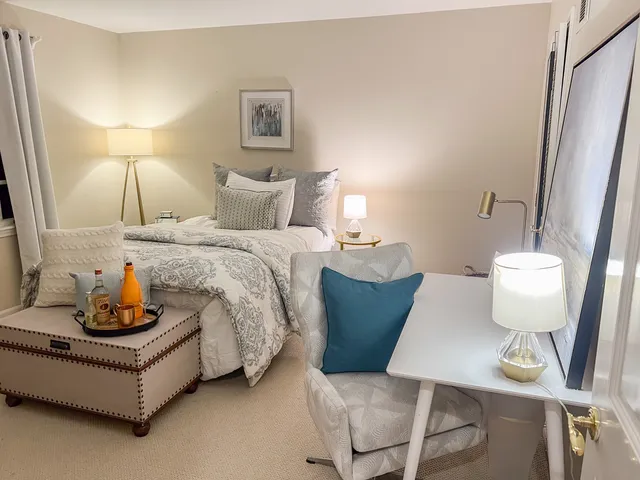 a spacious bedroom with a bed and a couch