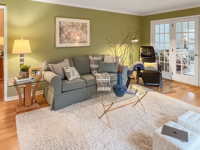 a living room with furniture and a lamp