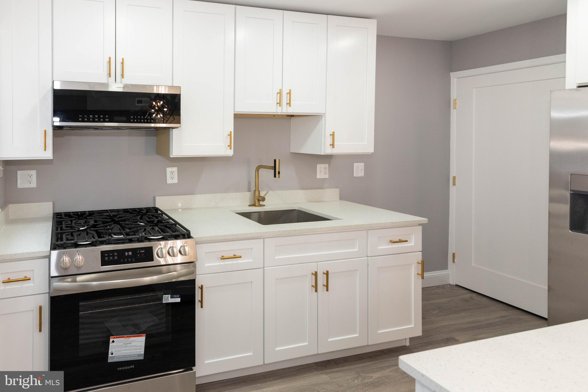 4843 Greencrest Road Baltimore, MD 21206 - Photo 11 of 44 a kitchen with stainless steel appliances a stove a microwave and cabinets