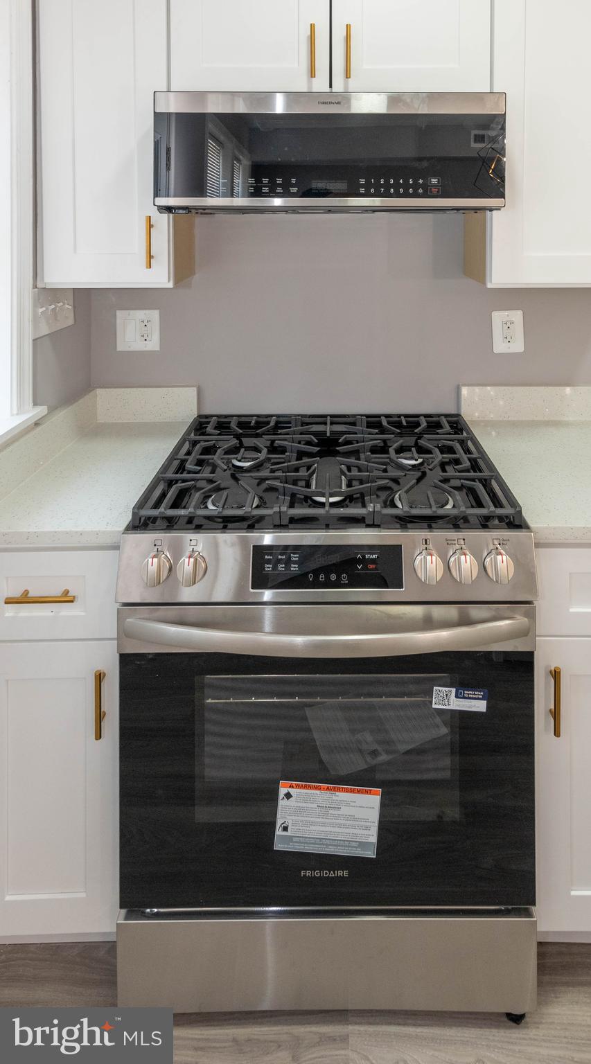 4843 Greencrest Road Baltimore, MD 21206 - Photo 12 of 44 a stove top oven sitting inside of a kitchen