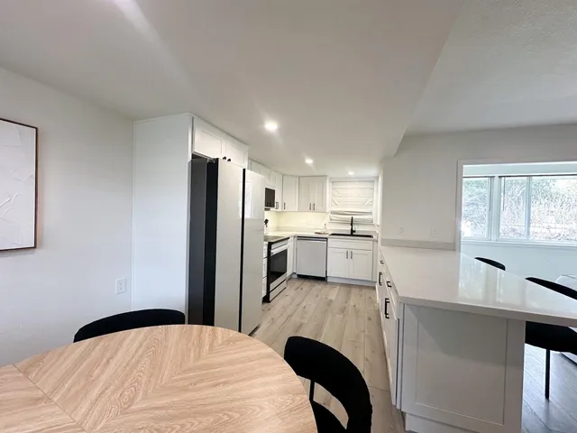 a kitchen with a refrigerator and a sink