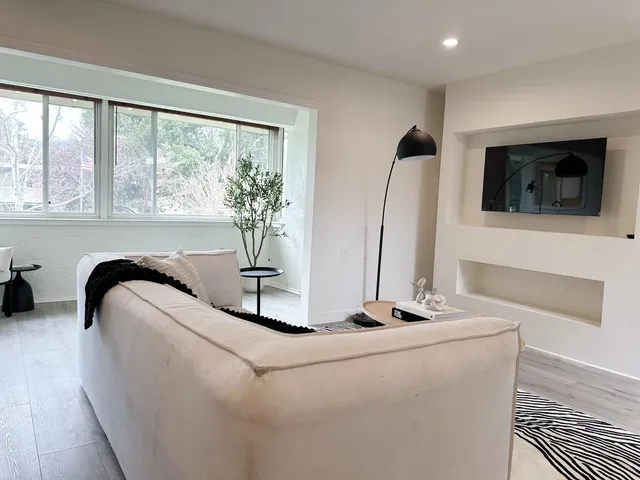 a living room with furniture and flat screen tv