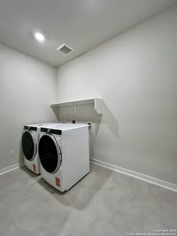 a kitchen with stainless steel appliances granite countertop a refrigerator a sink and a stove