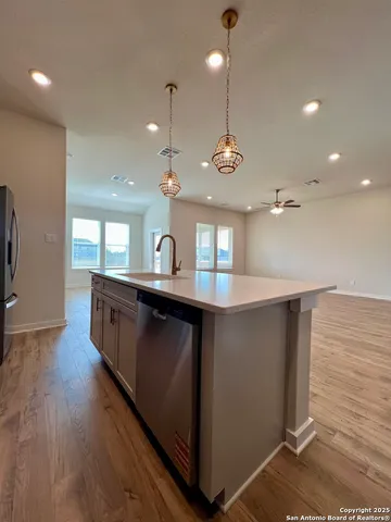 a view of an empty room with stairs and a window