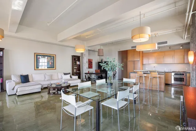 a living room with fireplace furniture and a chandelier