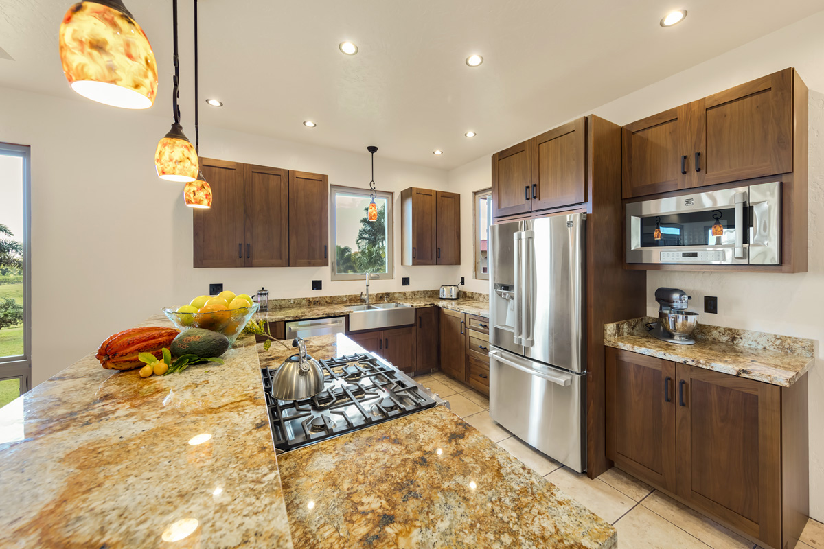 13-308 Kamaili Road Pahoa, HI 96778 - Photo 16 of 29 a kitchen with stainless steel appliances granite countertop a refrigerator and a stove top oven