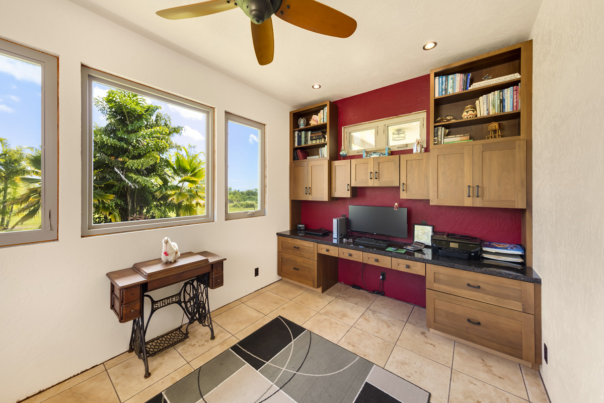 13-308 Kamaili Road Pahoa, HI 96778 - Photo 18 of 29 a kitchen with stainless steel appliances kitchen island granite countertop a stove and a flat screen tv