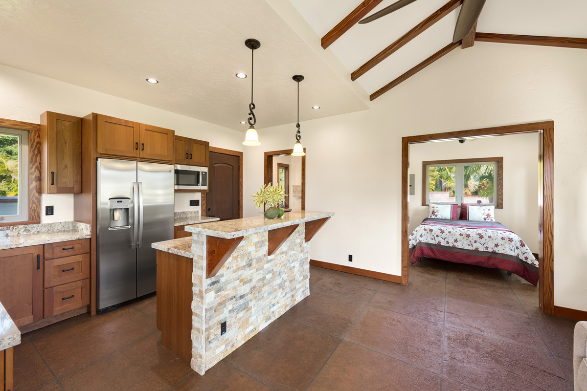 13-308 Kamaili Road Pahoa, HI 96778 - Photo 24 of 29 a view of kitchen with stainless steel appliances granite countertop a stove and a refrigerator