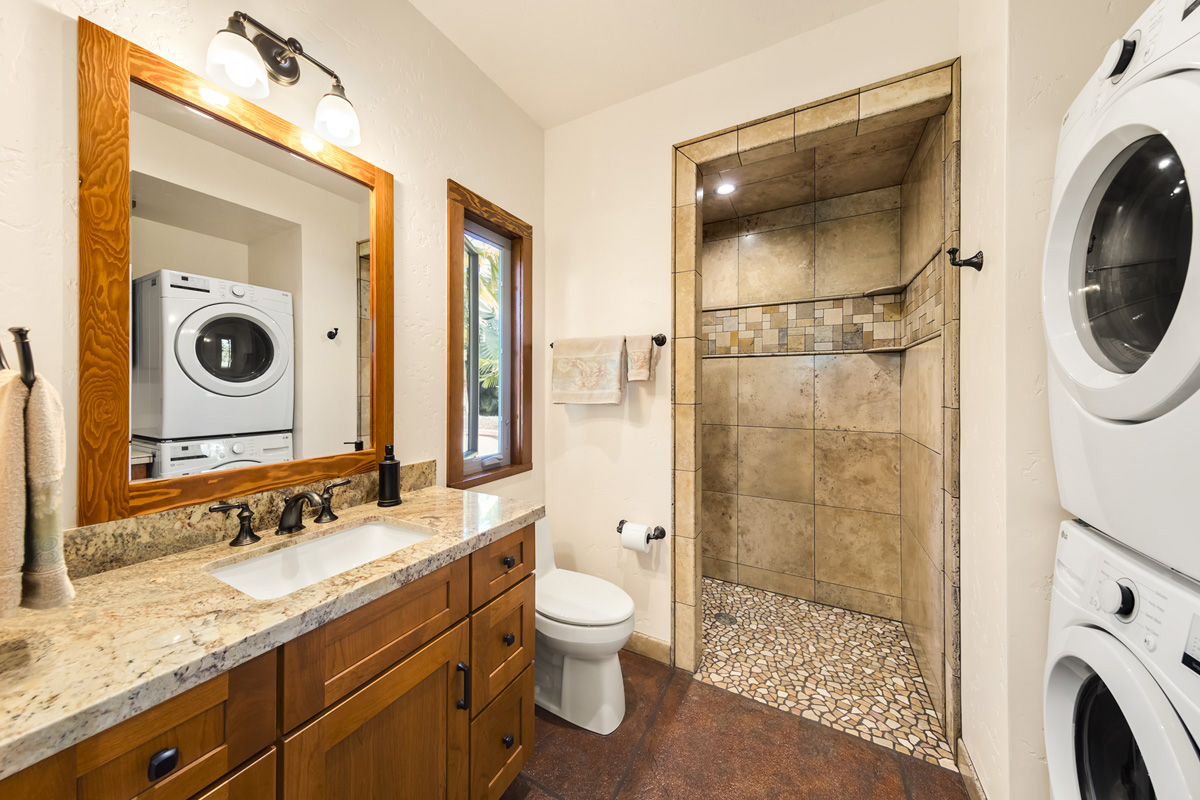13-308 Kamaili Road Pahoa, HI 96778 - Photo 25 of 29 a bathroom with a granite countertop toilet sink and mirror