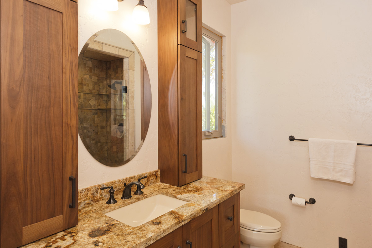 13-308 Kamaili Road Pahoa, HI 96778 - Photo 26 of 29 a bathroom with a granite countertop sink a mirror and a toilet