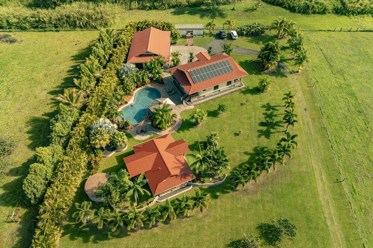 13-308 Kamaili Road Pahoa, HI 96778 - Photo 6 of 29 an aerial view of a house with a garden and lake view
