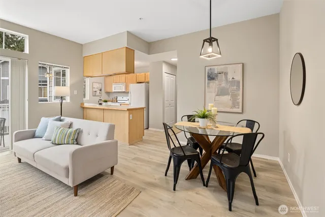 a living room with furniture a dining table and a chandelier