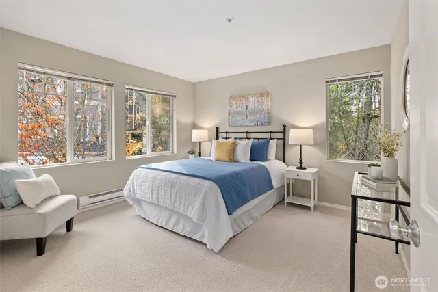 a bedroom with a bed and a large window