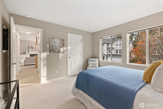 a spacious bedroom with a bed and glass door