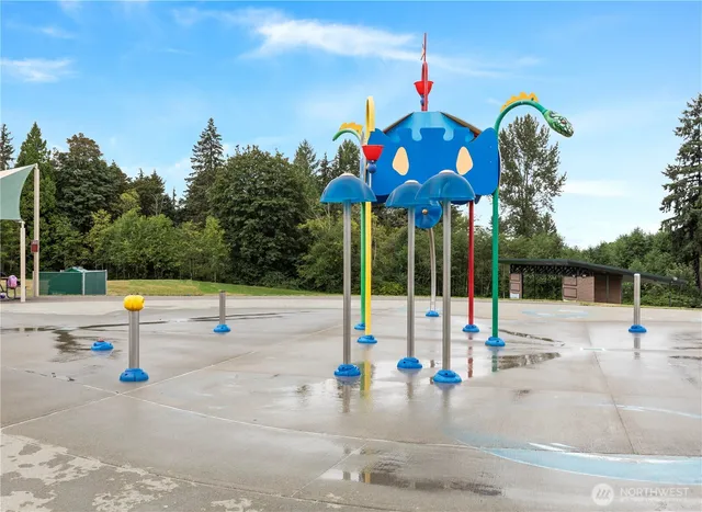 a view of a swimming pool with lawn chairs and plants