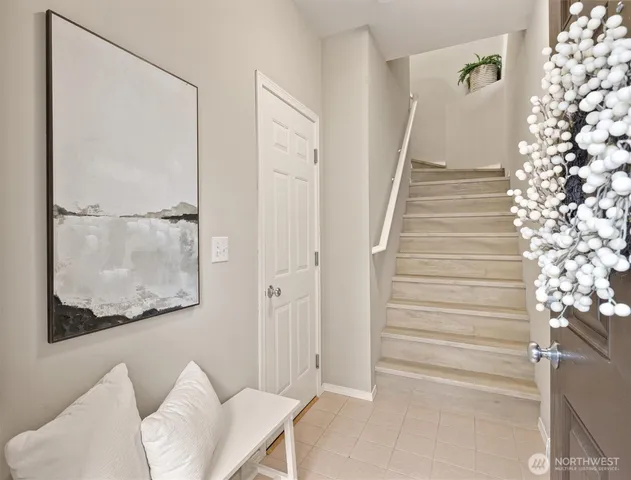 a view of a hallway with couches and dinning table