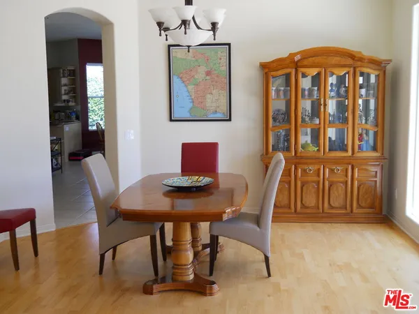 a view of a workspace with furniture window and wooden floor