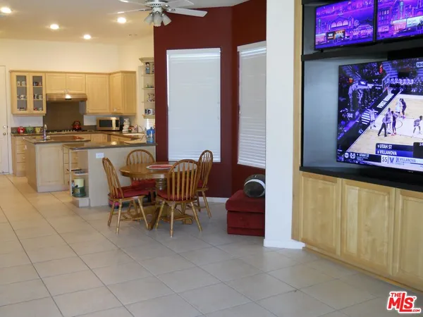 a view of kitchen with stainless steel appliances kitchen island granite countertop dining room