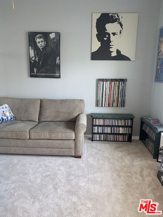6 Thatcher Court Rancho Mirage, CA 92270 - Photo 18 of 25 a living room with furniture and a shelf