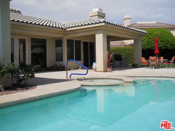 a view of a house with sitting area and garden