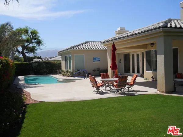 a view of a patio with table and chairs and potted plants