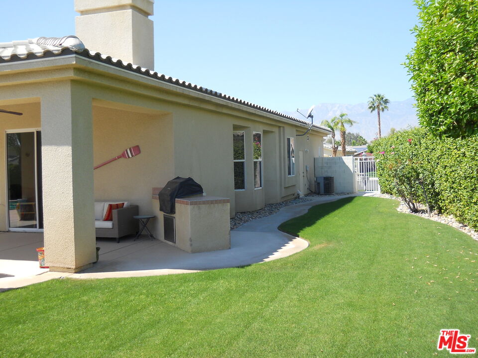 6 Thatcher Court Rancho Mirage, CA 92270 - Photo 24 of 25 a front view of a house with a yard