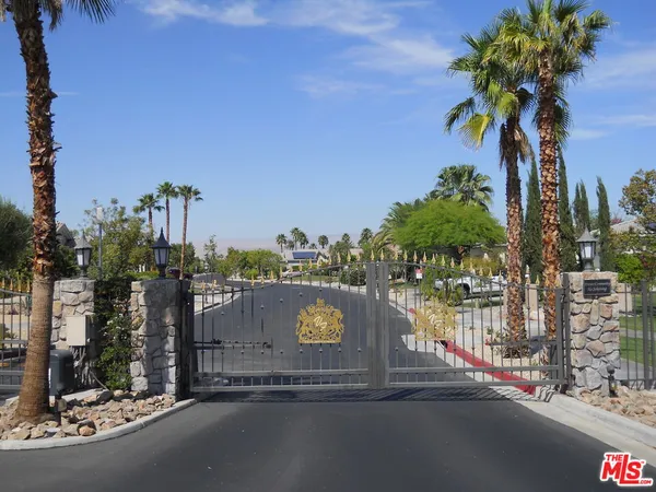 a view of a street with palm trees