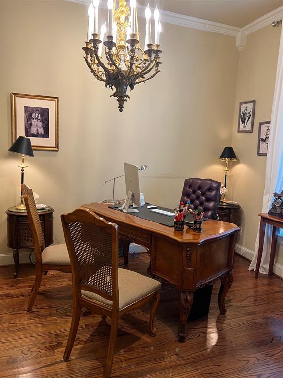 1625 Roma Lane Allen, TX 75013 - Photo 2 of 10 Formal room featuring an ornate brass chandelier, crown molding, a decorative corner corbel, and wood-finish flooring