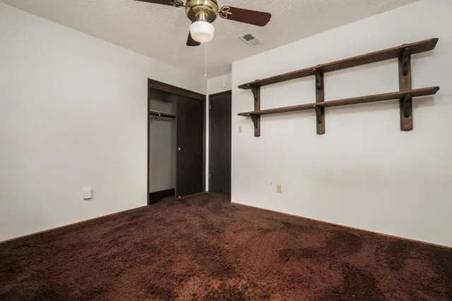 an empty room with a ceiling fan