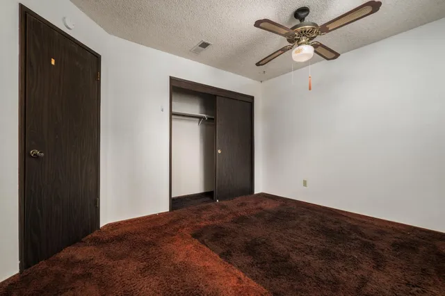 a view of a big room with a ceiling fan and a chandelier fan