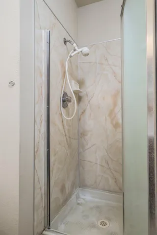 a bathroom with a glass shower door