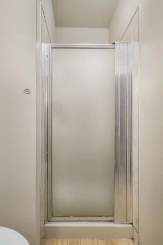 a bathroom with a glass shower door