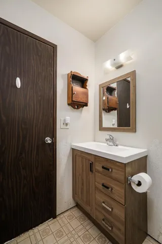 a bathroom with a toilet a double vanity sink and mirror