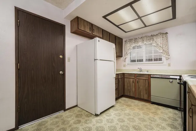 a kitchen with a refrigerator and a sink