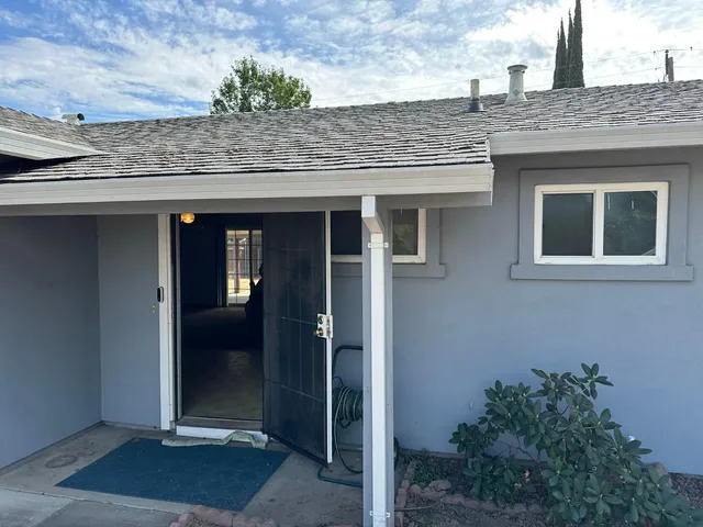 a view of a wooden door of the house
