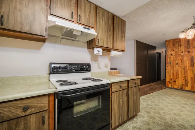 a kitchen with stainless steel appliances granite countertop a stove a refrigerator and a sink