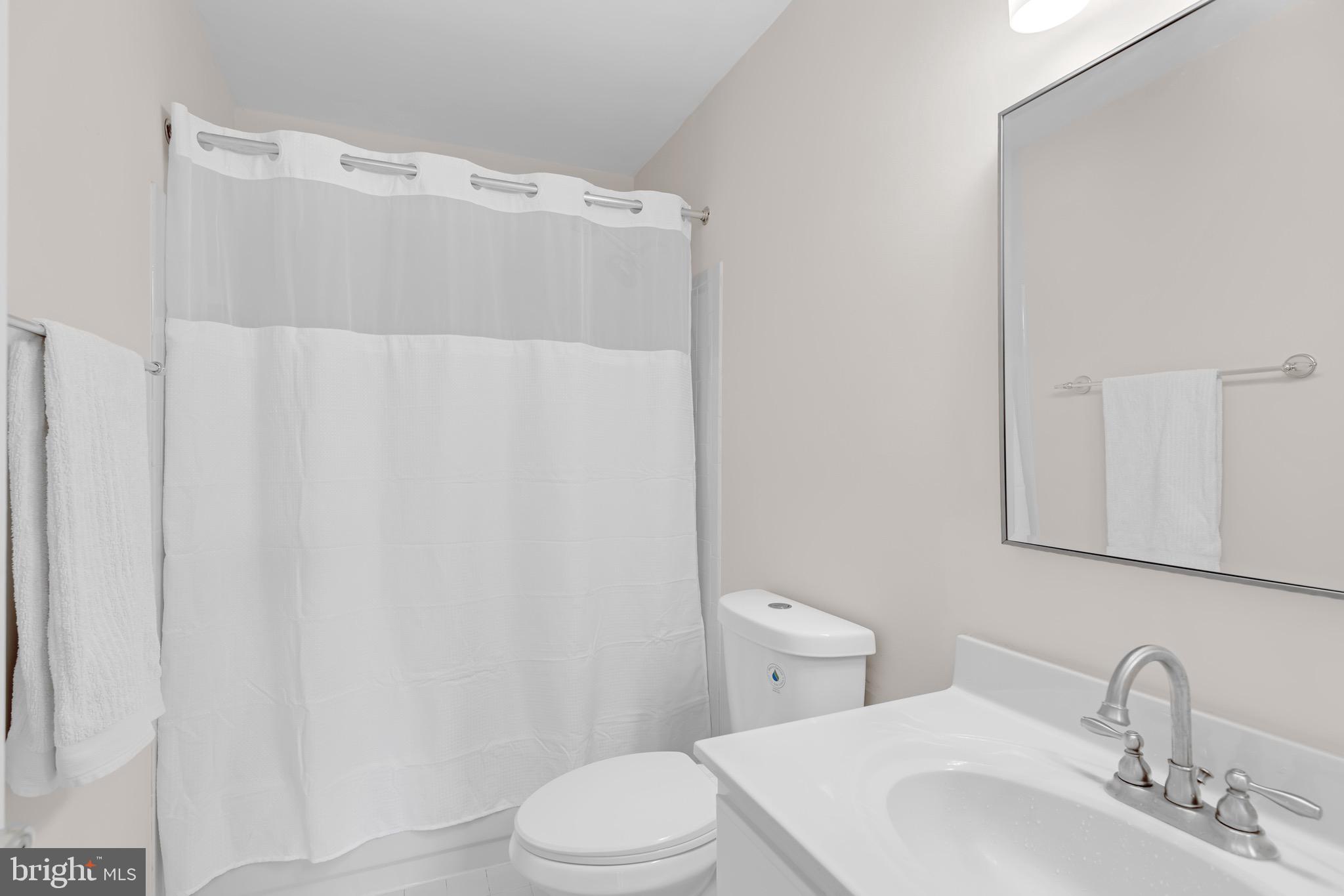 8110 Squirrel Run Road Springfield, VA 22152 - Photo 33 of 53 a white toilet sitting next to a bathroom sink