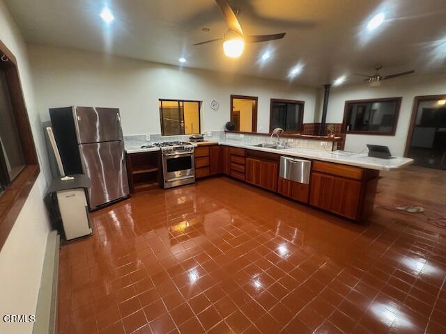 19200 Tramway Navarro, CA 95463 - Photo 15 of 50 a large kitchen with stainless steel appliances a large counter top a stove a chimney a sink and a refrigerator