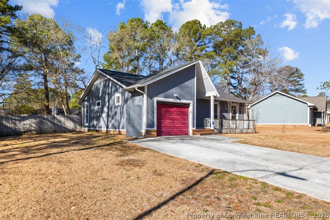 3305 Hunting Bay Drive Spring Lake, NC 28390 - Photo 3 of 27 a front view of a house with a yard and garage